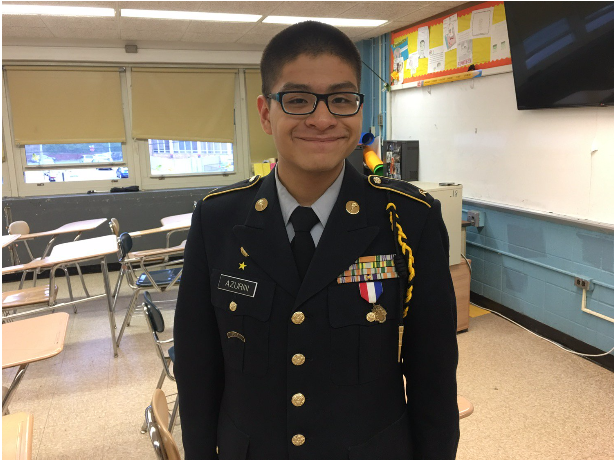 Billy standing proud in his uniform, decorated with various awards, a medal, and a cord he earned throughout his years in Francis Lewis.
