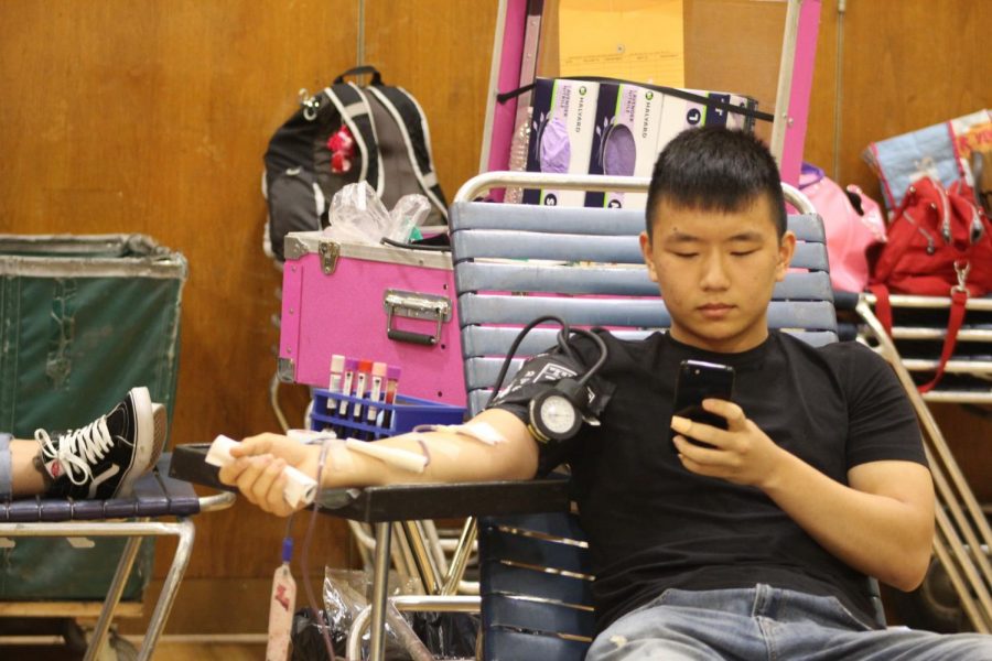 Francis Lewis student Damion Kim donates blood on October 5 in the gymnasium. 