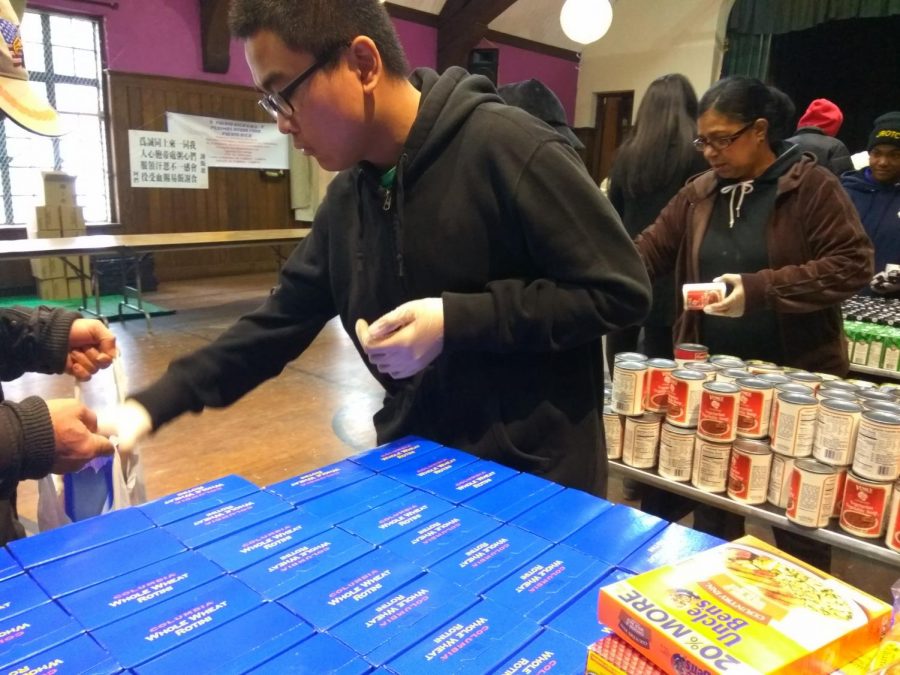 Volunteers distribute food donations at the St. George Church in Flushing. 