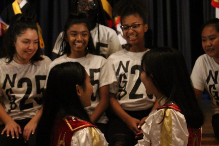The girls Step Team taught Korean students to step simple routines onstage, and now get ready for a group picture. (top) Step team members and (bottom) Korean cheerleading squad interact with each other. 
