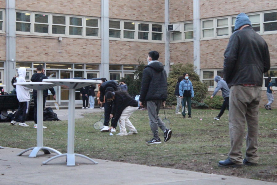 The meeting is coming towards the end of session and students help out by picking up stray birdies and begin to put away the equipment. 