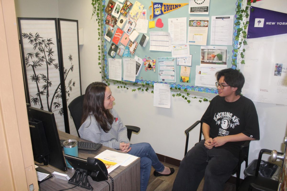 A student discusses trade school and alternative post-graduation pathways with college counselor Ms. Sperandino
