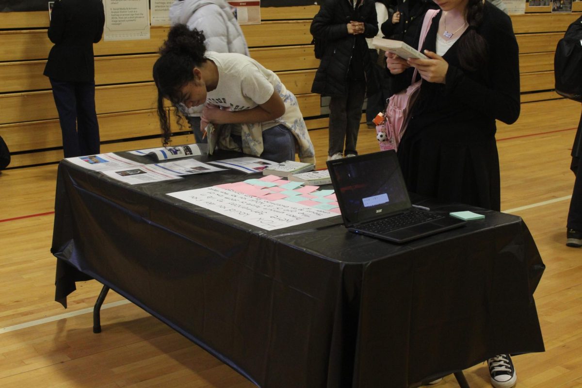 Students look closely at the details of a station as the case reels them in
