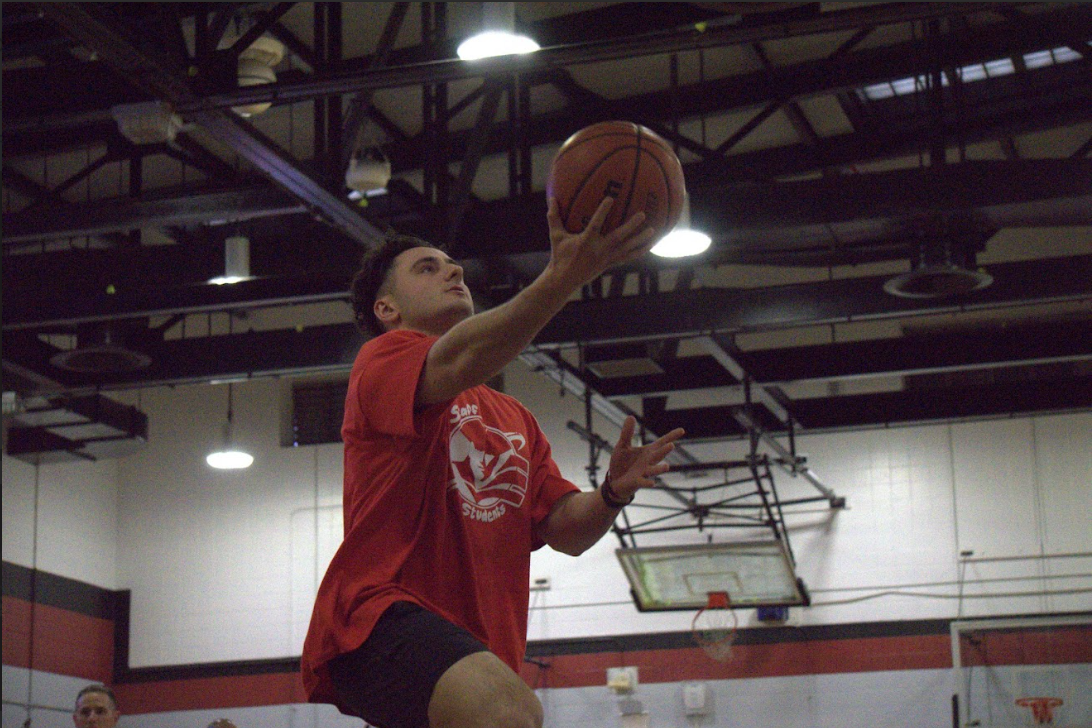 To start warmups before the game, Mr. Pomara goes up for a layup in layup lines.