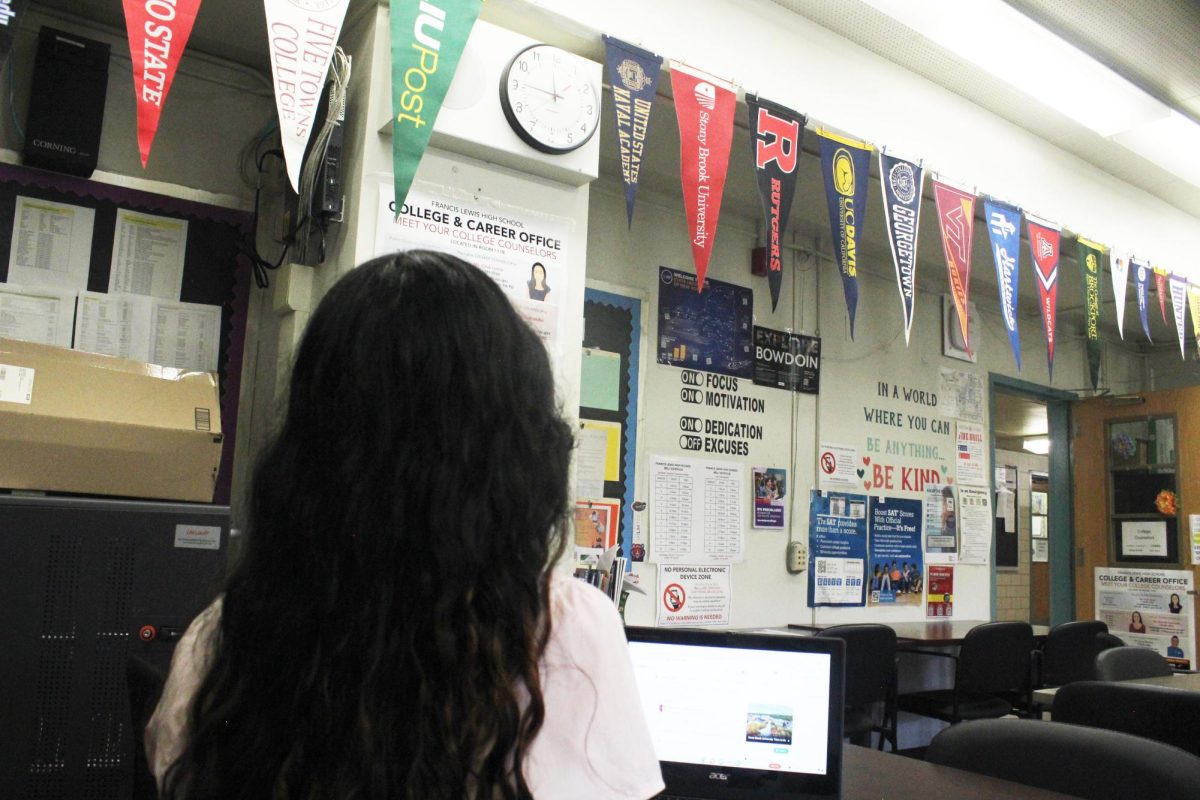 Junior Ashley Lucero, reviewing the banners in the College Office